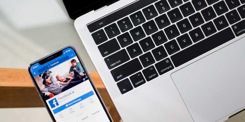 facebook mobile next to a laptop